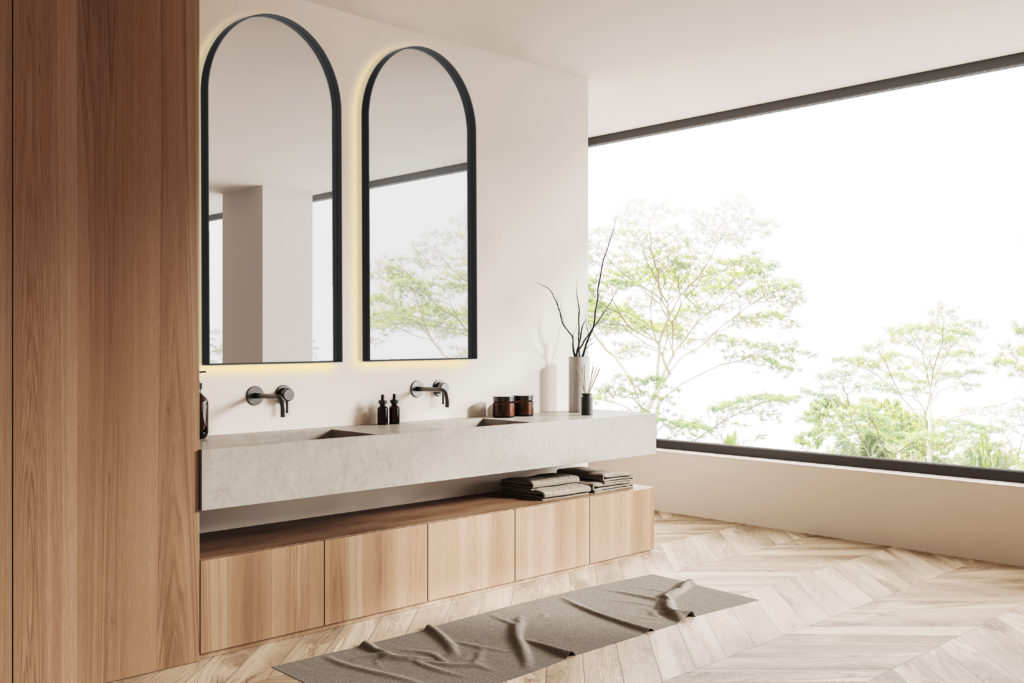Light bathroom interior with washbasins and accessories, panoramic window