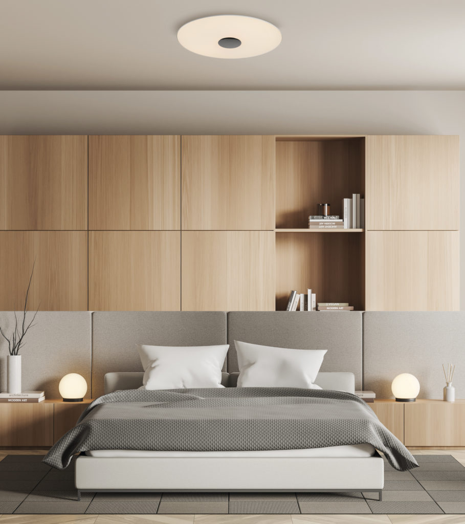 Stylish bedroom interior with bed and shelf with decoration